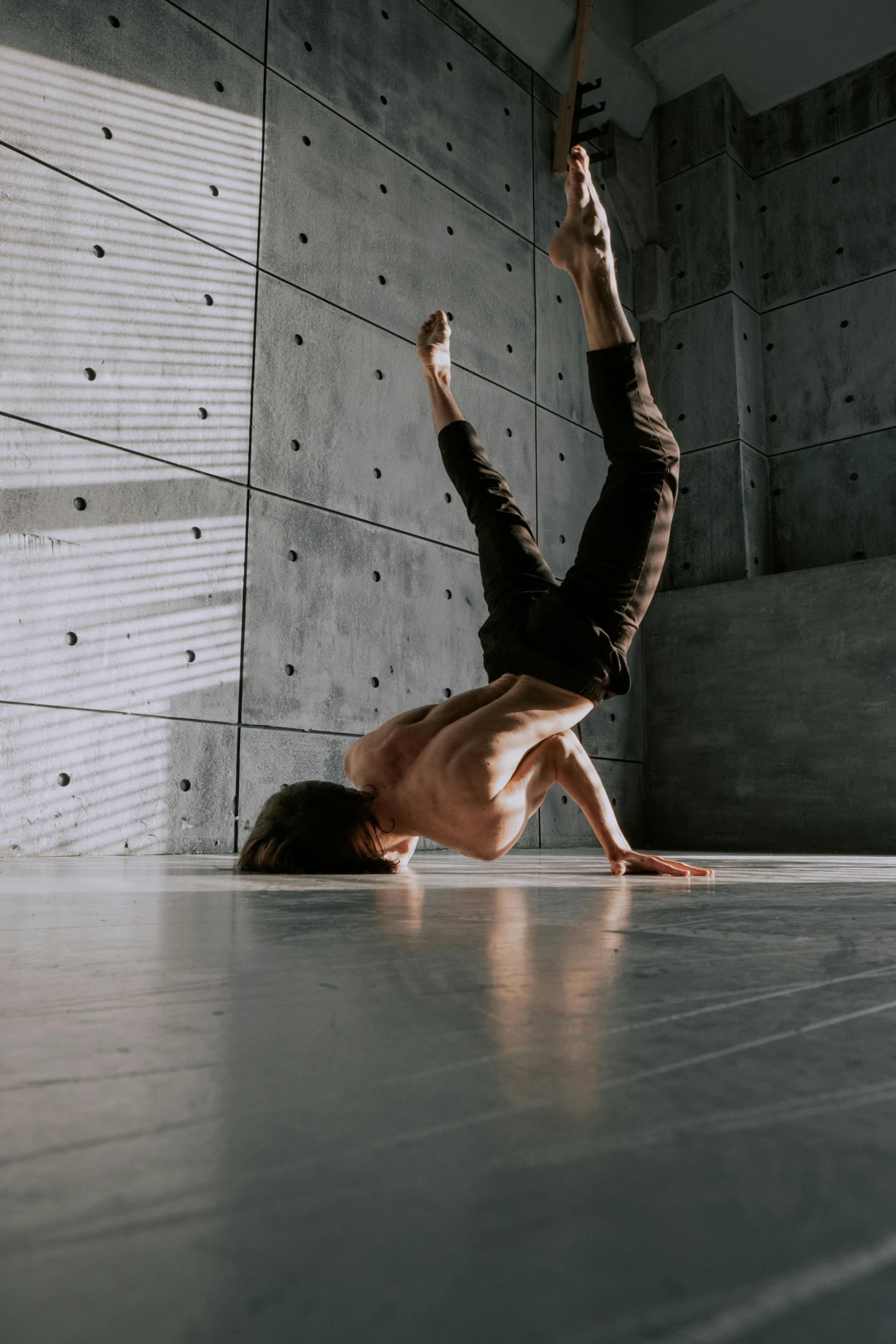 a man doing a handstand on the floor