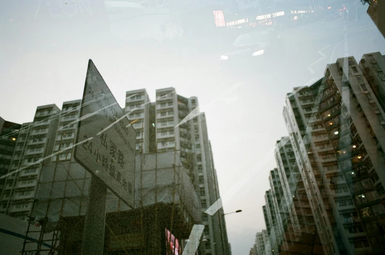 an image of the view through the glass in front of buildings