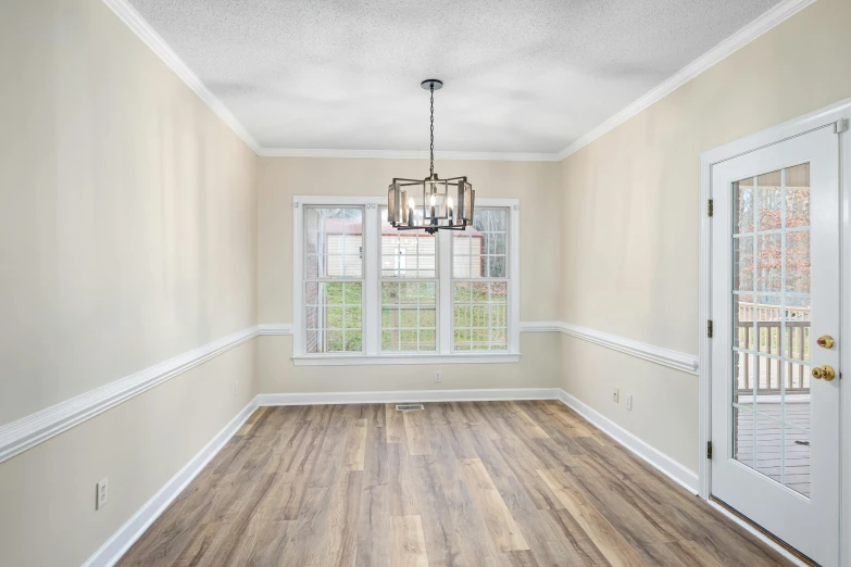 a room with white walls and hard wood floor