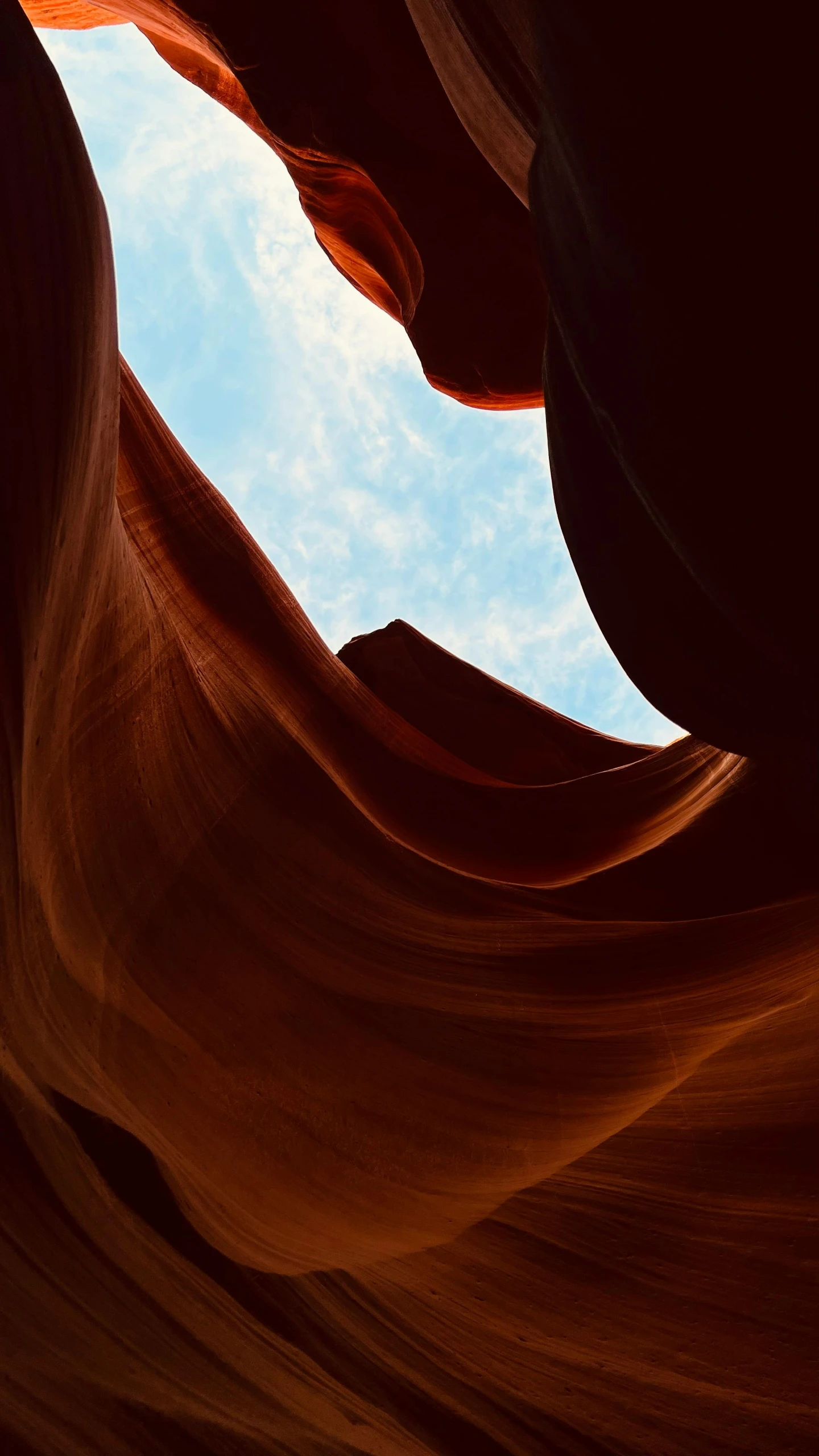 a bright sunny day shows off a small blue sky over a large canyon