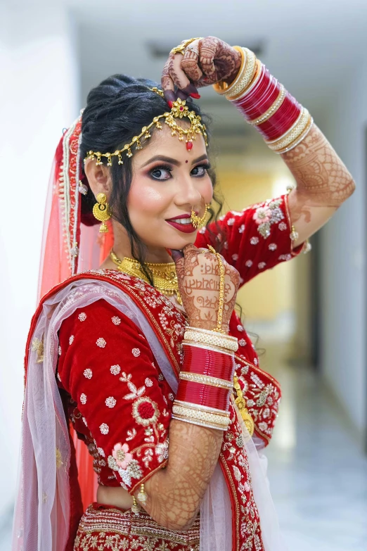 a beautiful woman in traditional indian garb poses for a picture