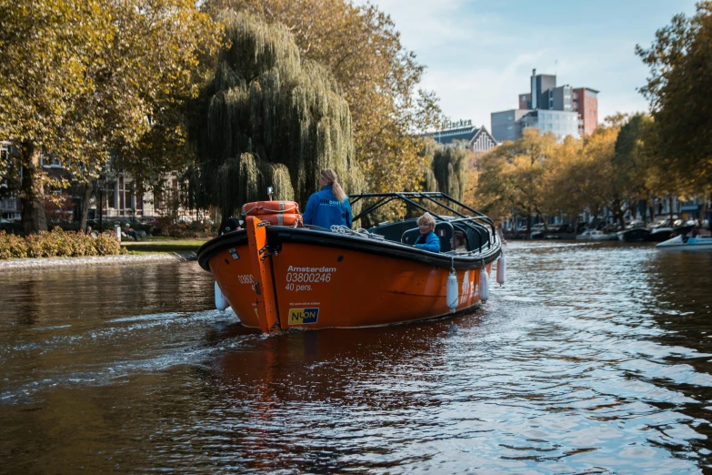 an old boat traveling down a river with several people inside