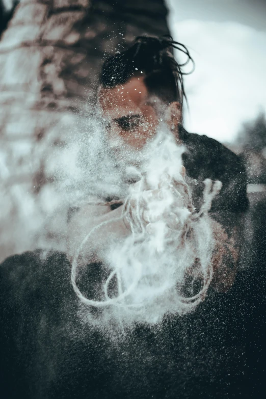 a man looking down in the smoke