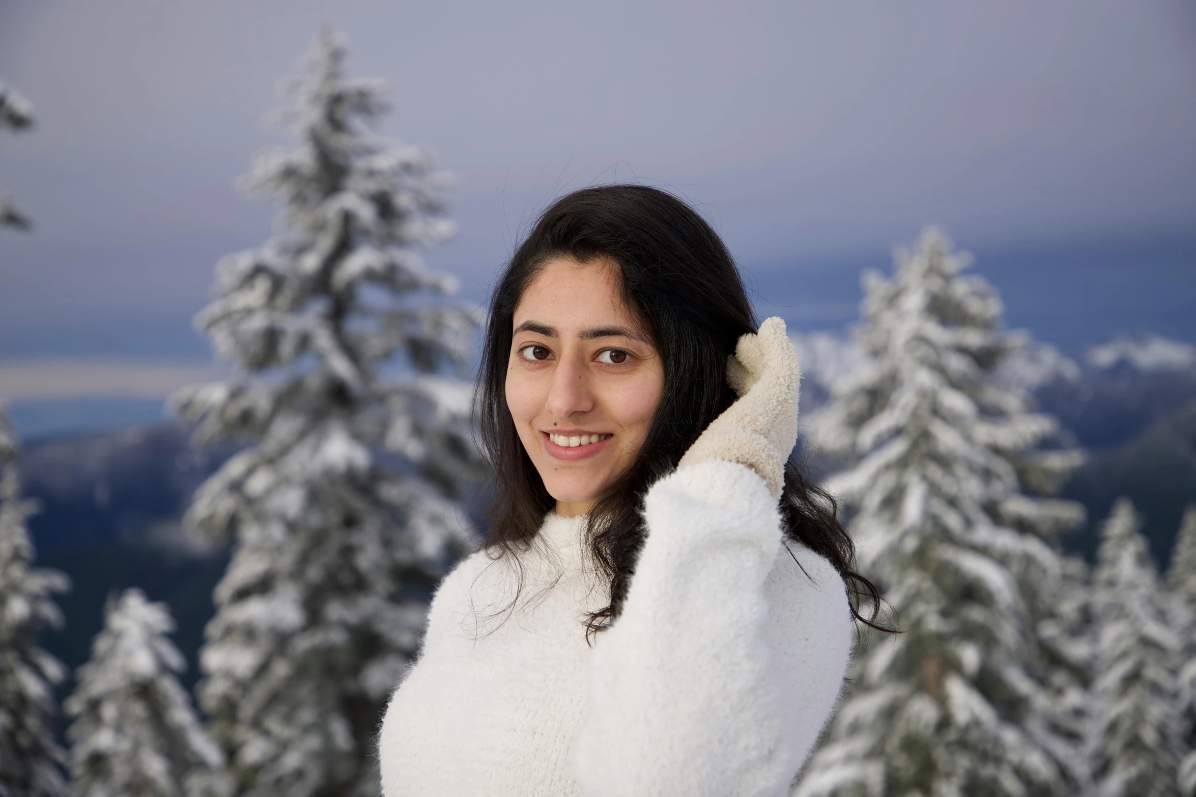 a woman in white is holding her hand on her head