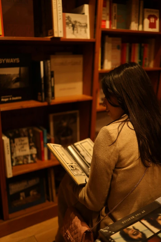 girl sits in a liry and looks over her book