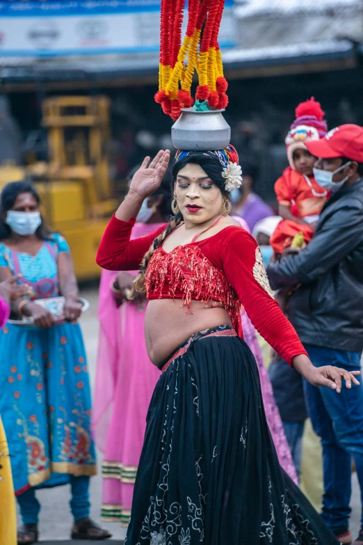 a woman standing next to a bunch of other people wearing masks