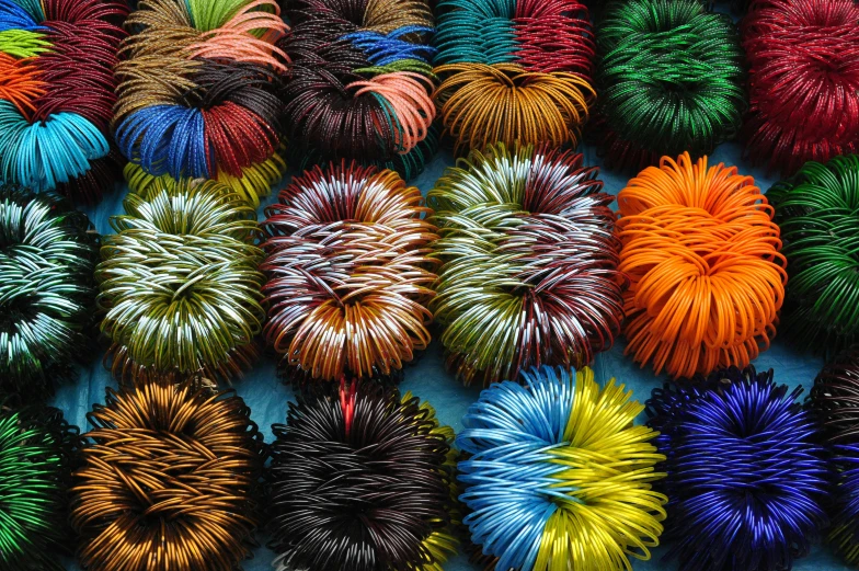a group of different color coils displayed in rows
