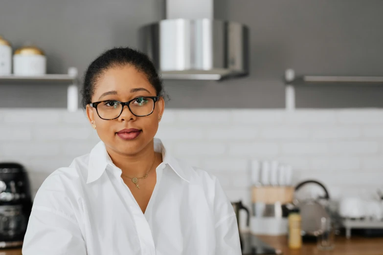 a woman in glasses posing for the camera