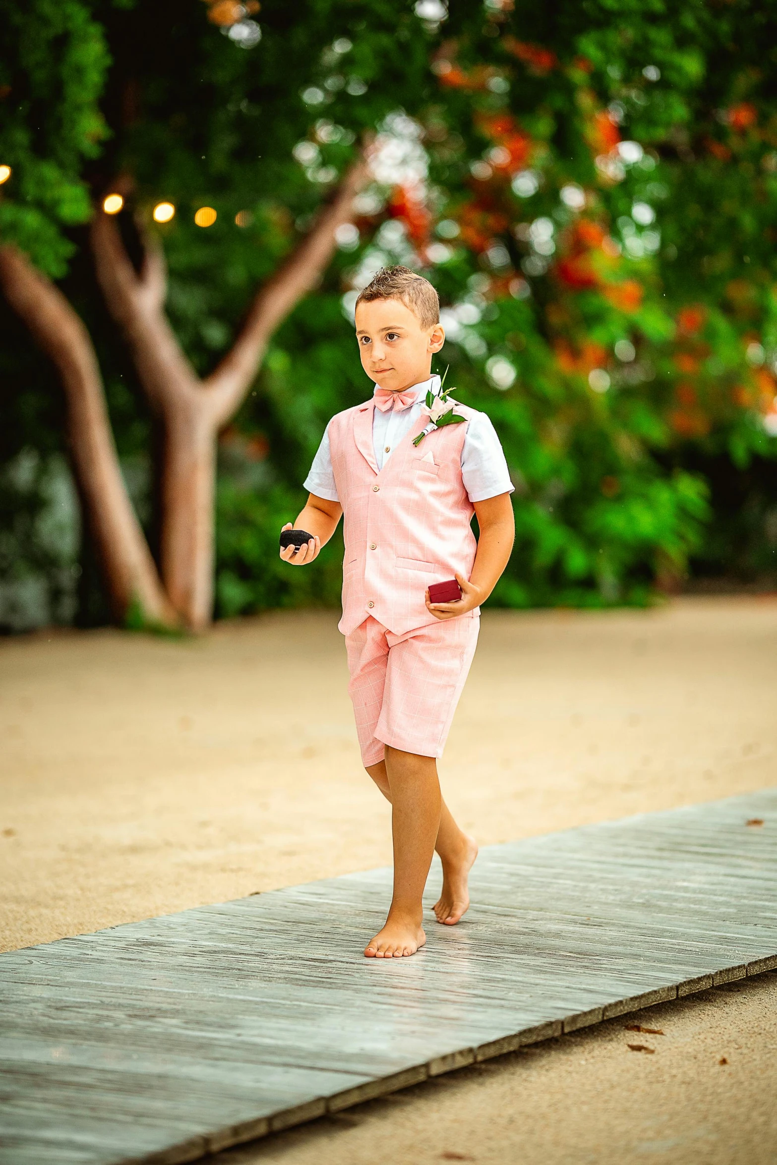 a small child is in a pink and white outfit