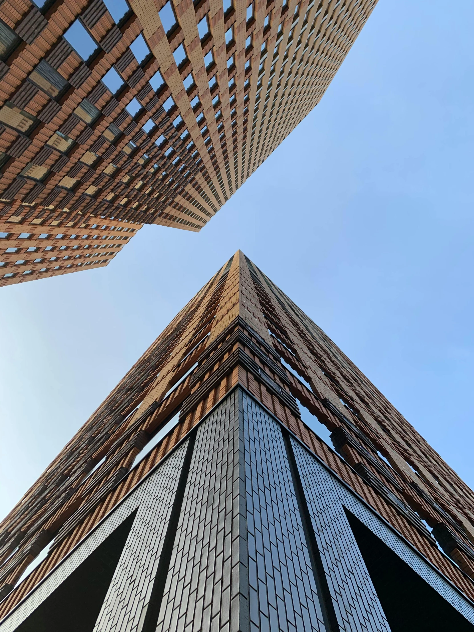 two buildings looking up with their windows on the outside