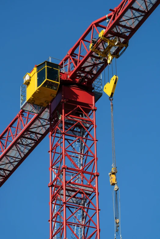 two cranes are set to work on a building