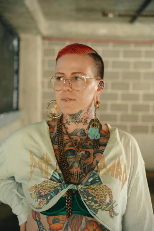 woman with full tattoos standing by her office