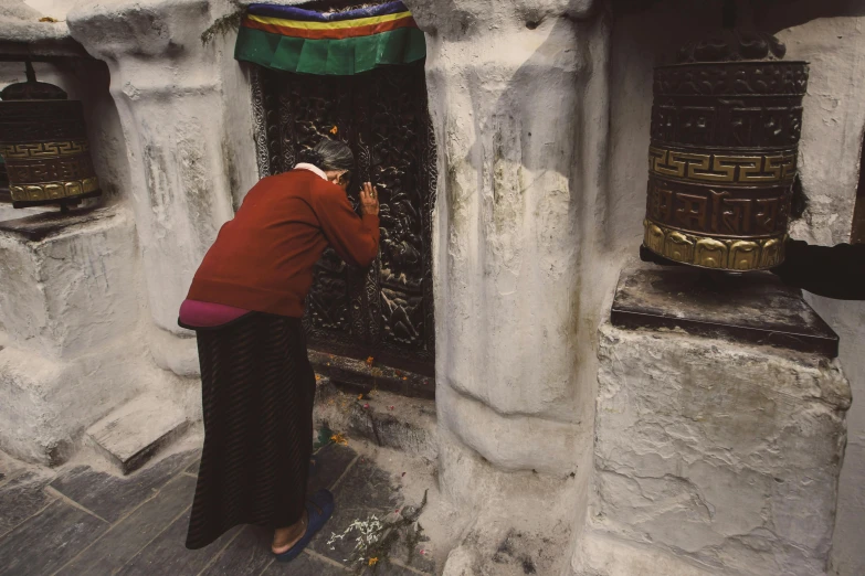 a woman standing in front of a temple doorway