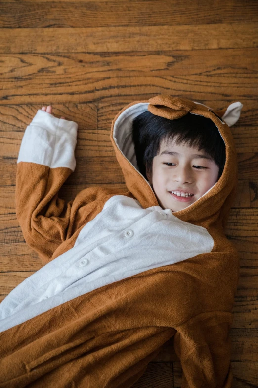 a small child laying on top of a wooden floor