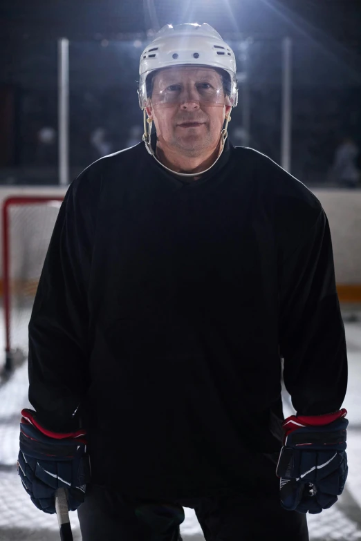 a man wearing hockey gear while standing in the snow