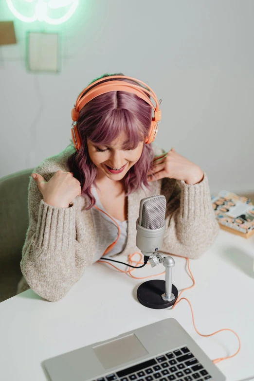 a young woman with headphones listening to a microphone