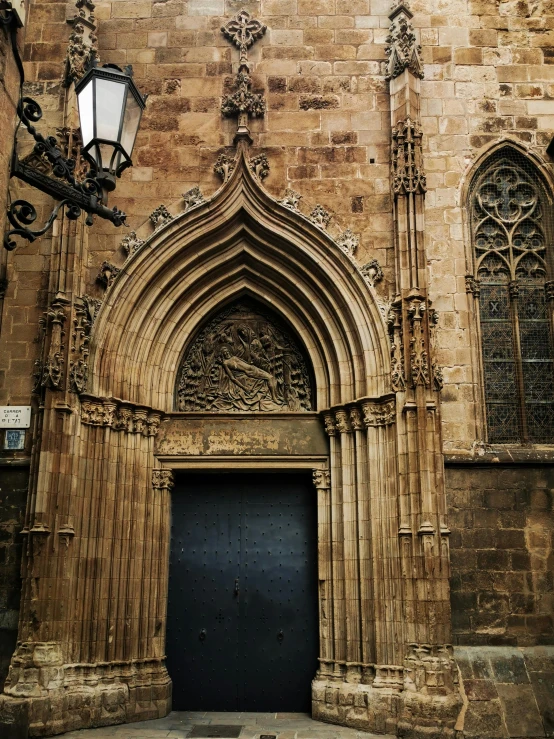 an ornate stone building with a black door