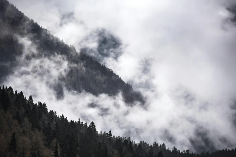 an image of clouds in the distance on a mountain