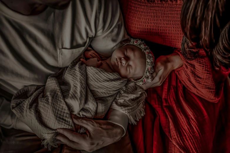 a painting of a man and woman holding a baby