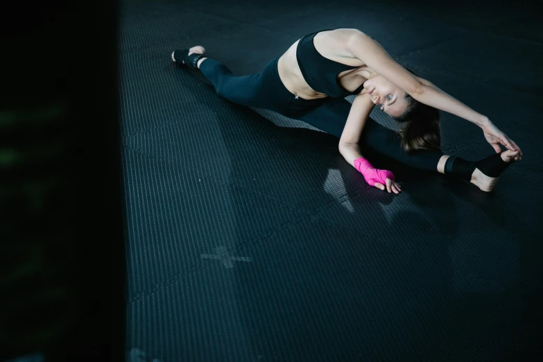 a woman standing on top of a black floor