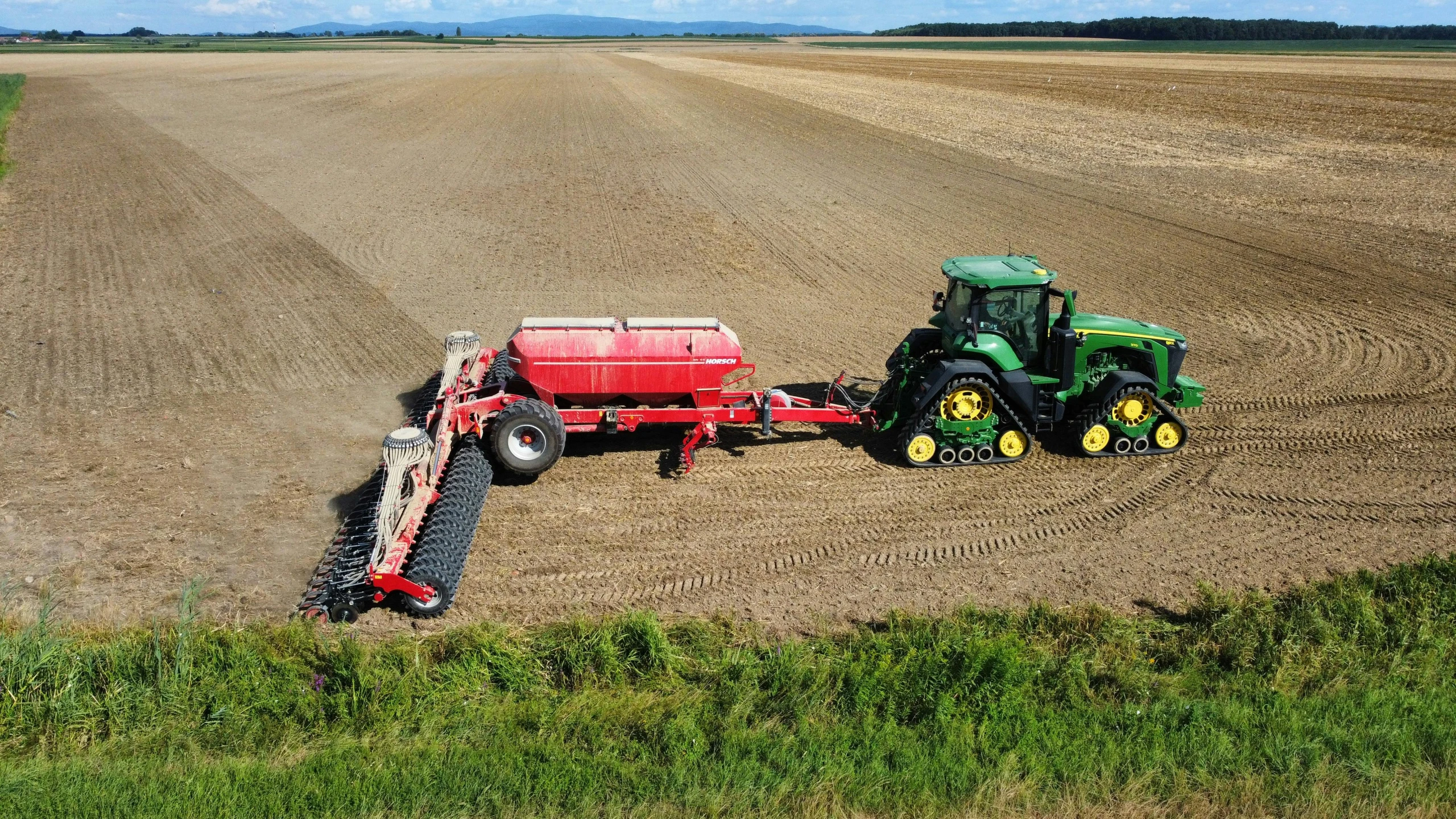 there are two tractors pulling a trailer on the plow