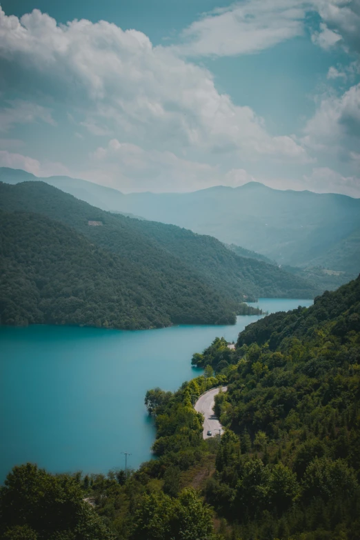 a scenic view of blue water and mountains