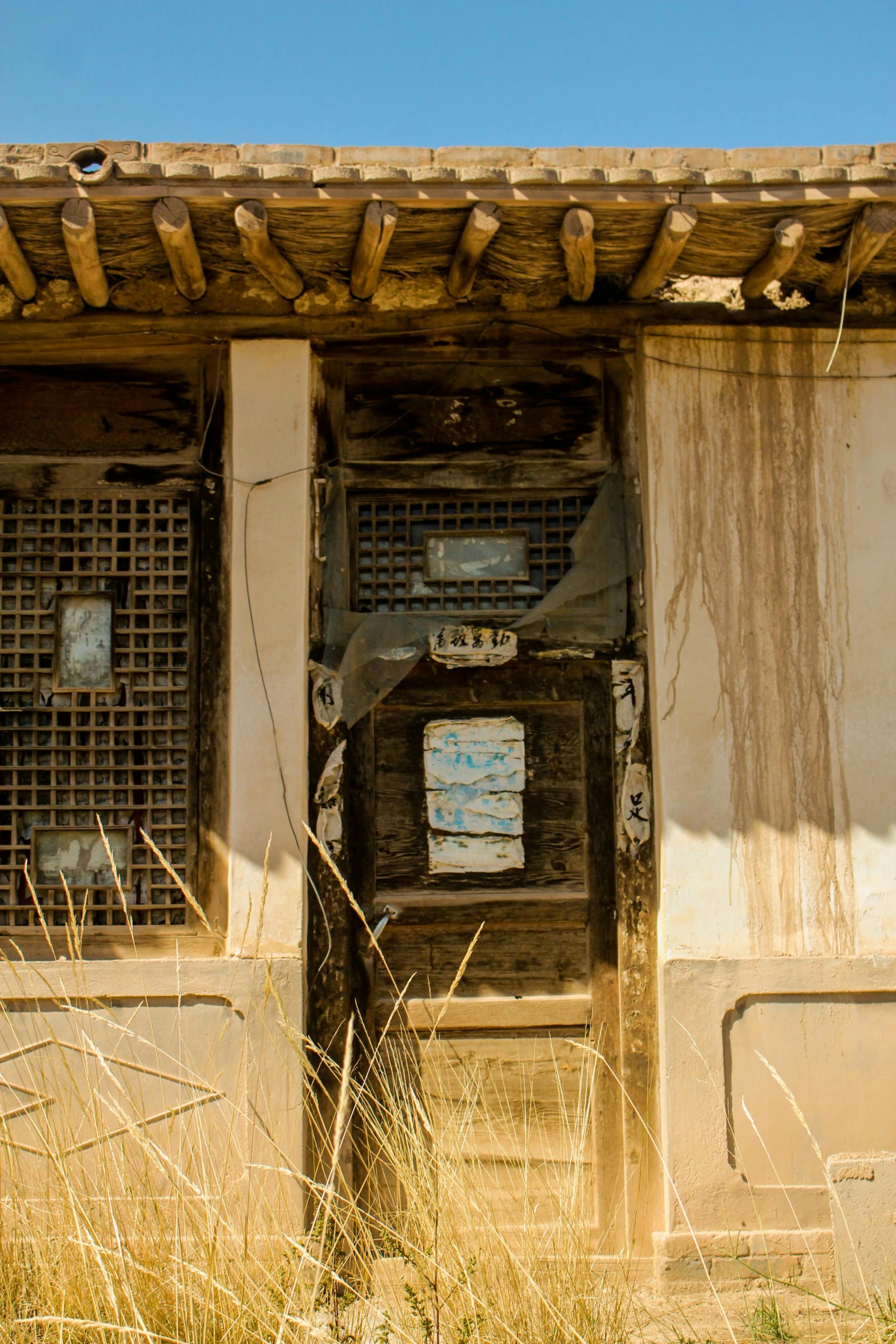 a doorway inside an old wooden building in a wheat field