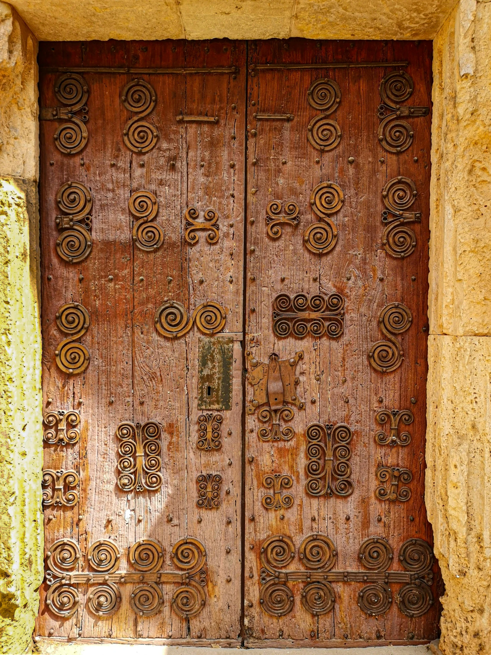 a close up of two brown wooden doors