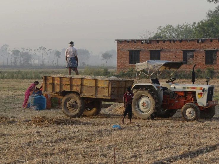 some people are standing by a large truck