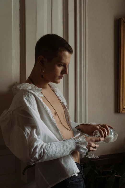 the young woman is wearing a white top and holding a wine glass