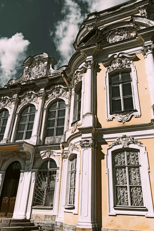 an older yellow house with arched windows and balconies