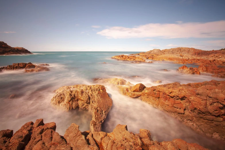 a large body of water sitting below rocky hills