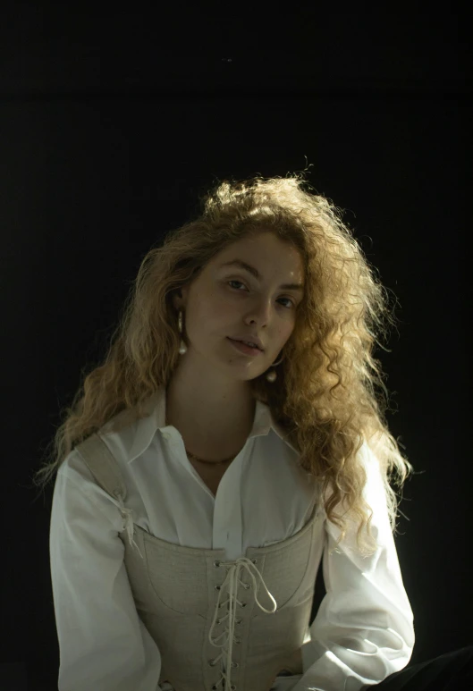 the young woman is sitting down with her hair blowing