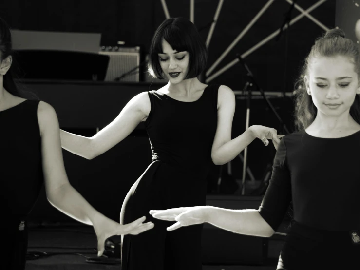 a group of women dancing together in a circle