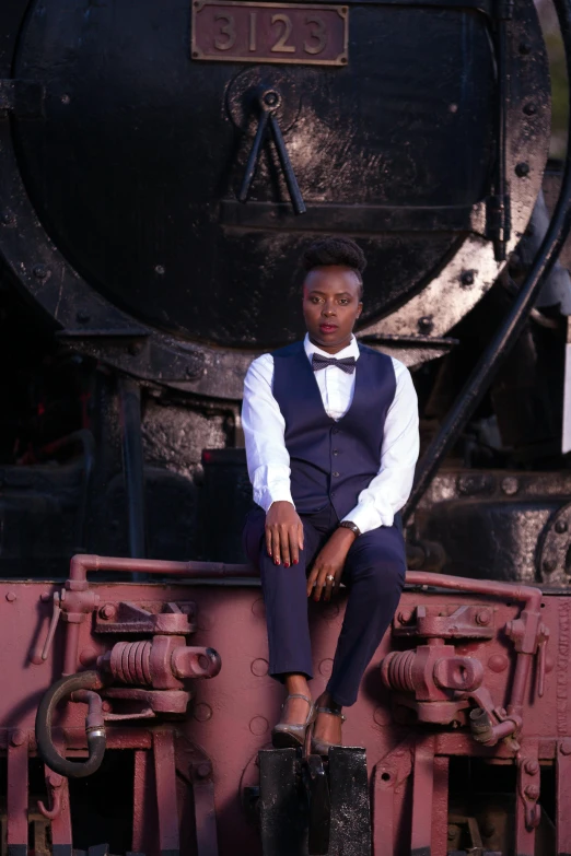 a man sitting in front of a locomotive