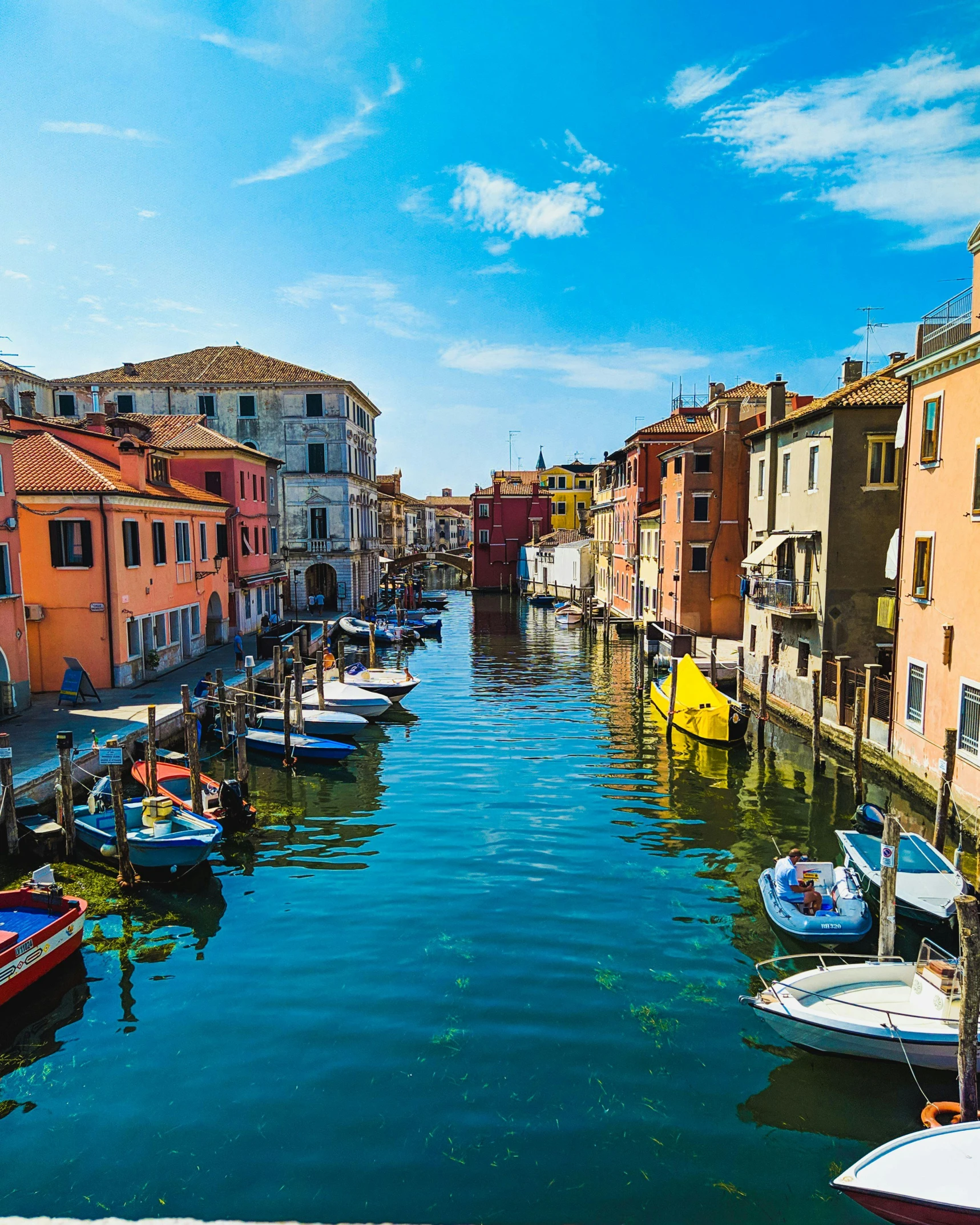 a group of boats in the water near a bunch of buildings