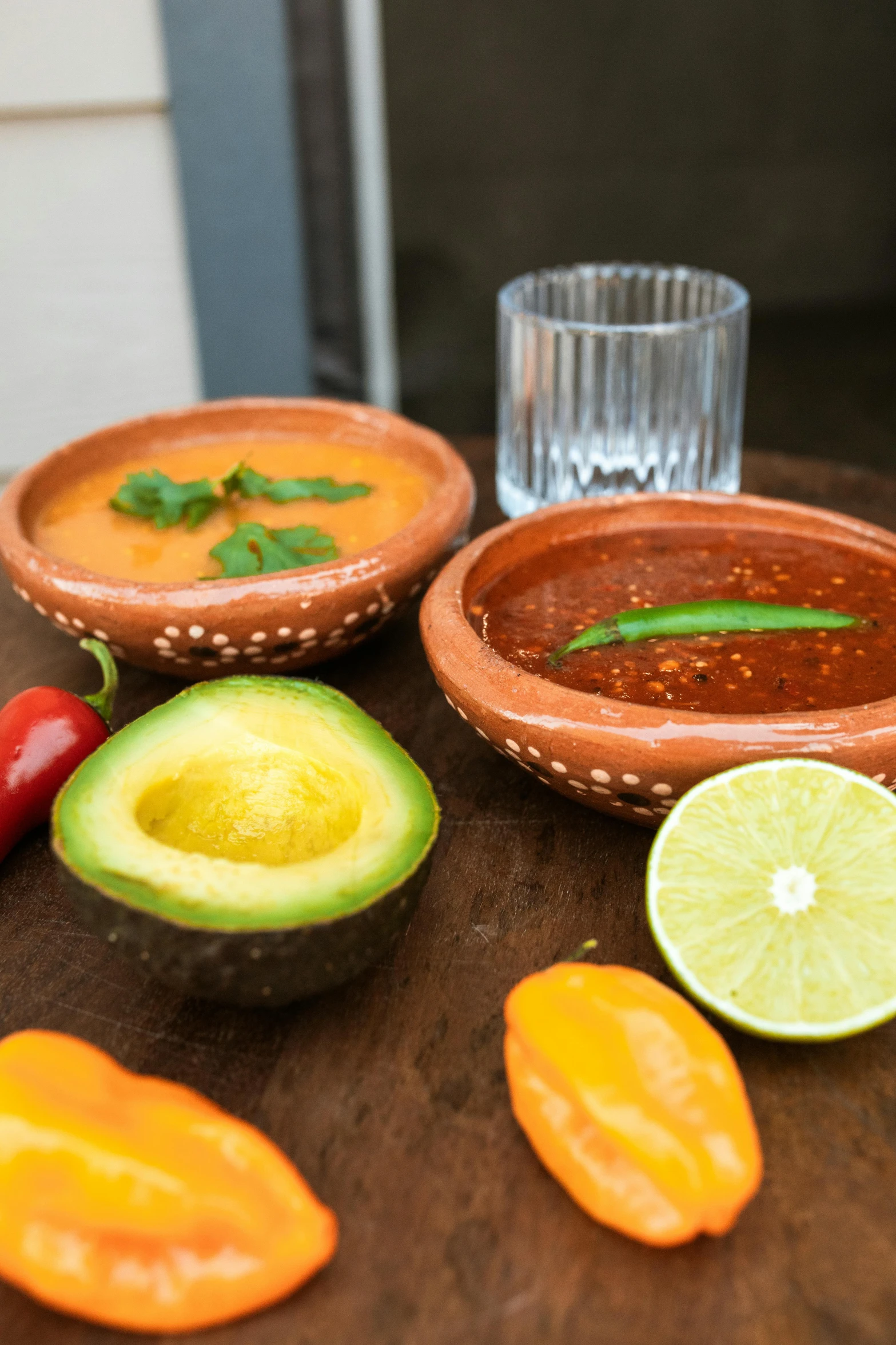 several different varieties of vegetables and fruits are on the table