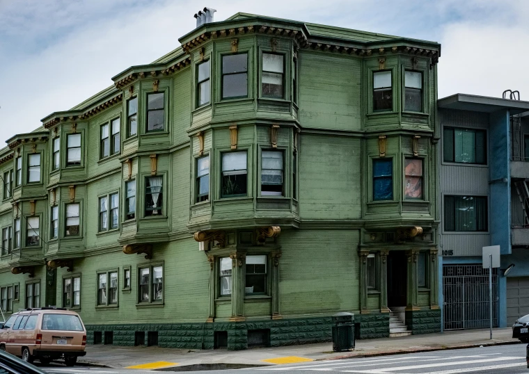 a street view of a building with multiple levels and several stories