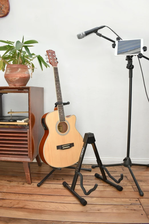 there is a small guitar that is sitting on the stand