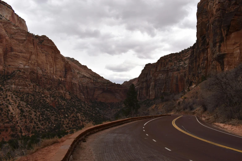 an empty mountain road leads through the valley