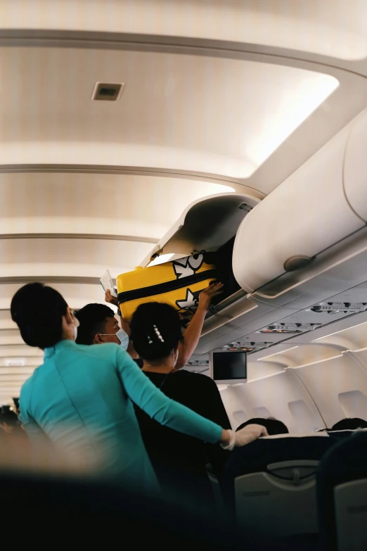 a couple of people with skis sitting on an airplane