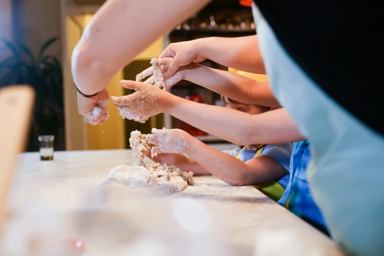 two people are making food on a table