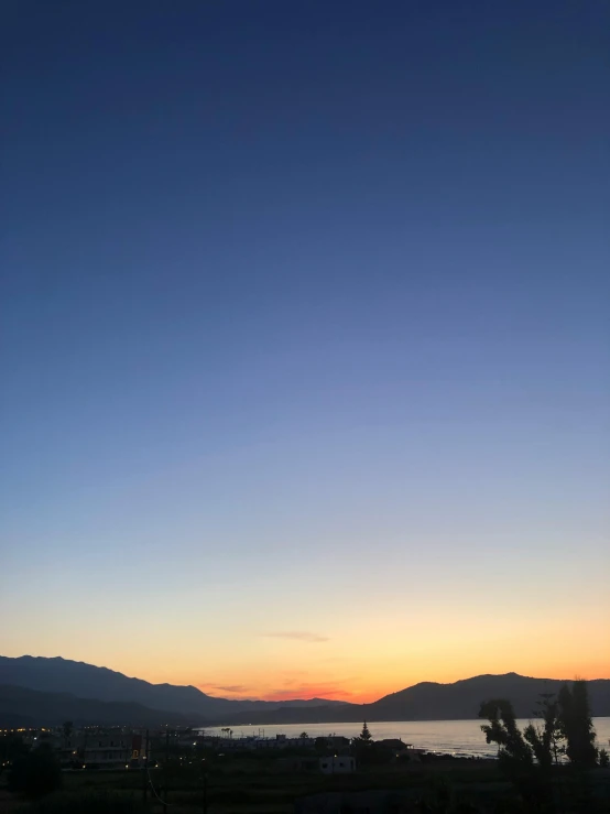 view from a hill with the setting sun in background