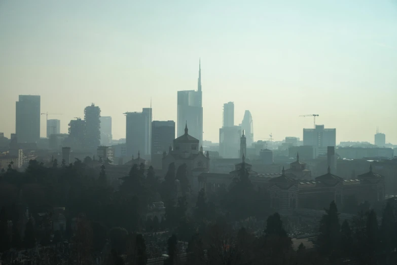 the city skyline is in heavy fog in the distance