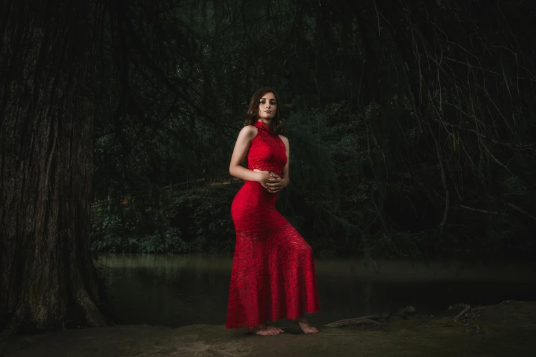 a woman in a long red dress posing