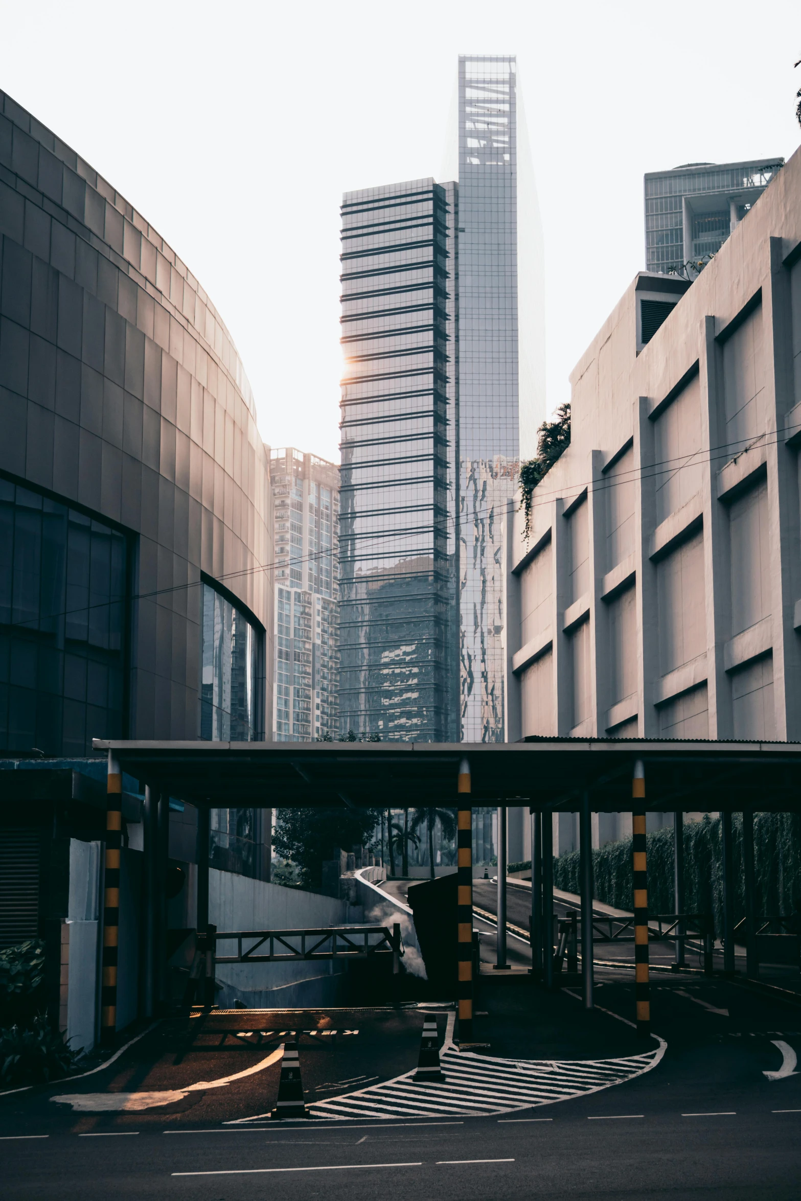 a bridge crossing a city street with buildings and cars