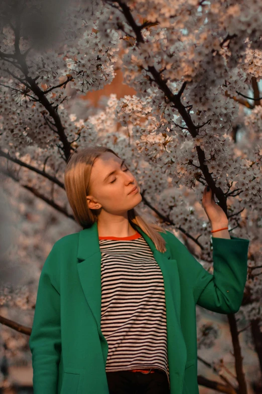 the woman is holding onto a cherry tree