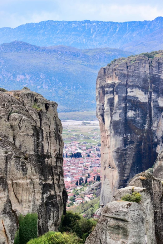 a view of the city of montail in the background of some rocky terrain