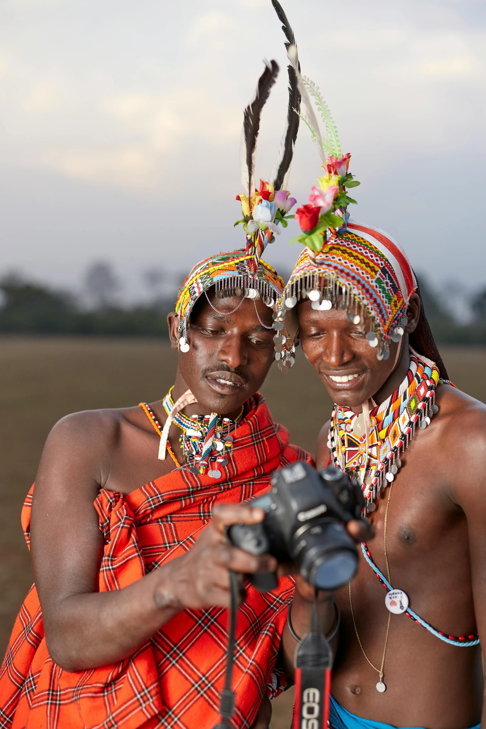 two men wearing head pieces and scarves standing together