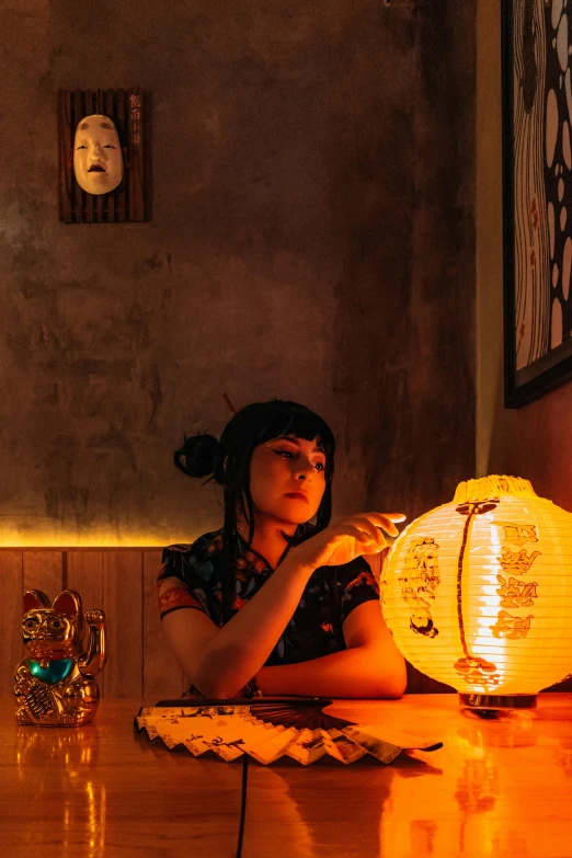 a woman sitting at a wooden table and looking away from her